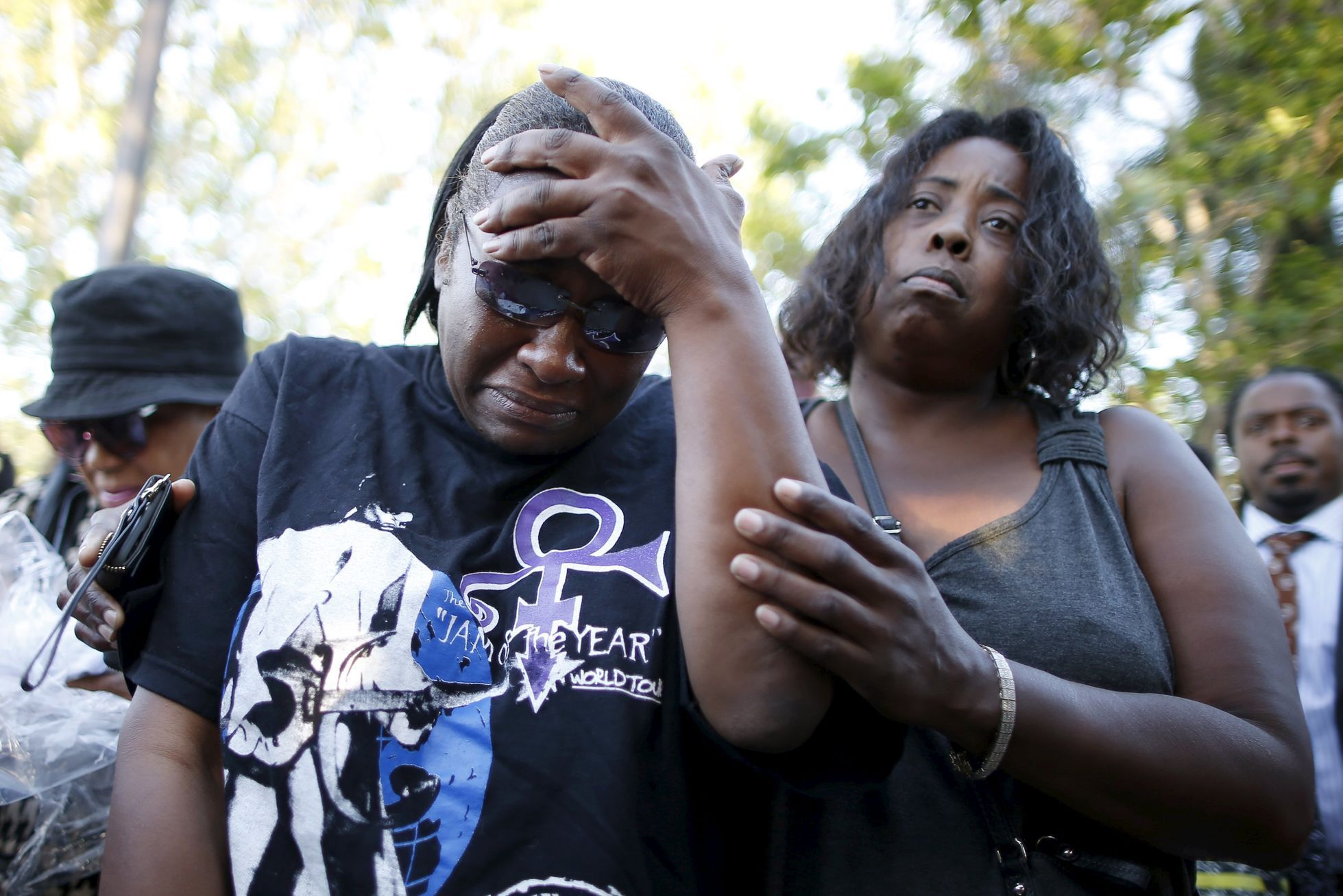 Loretta Thomas, 45, and Deshone, 50, listen to a Prince song at a vigil to celebrate the life and music of deceased musician Prince in Los Angeles