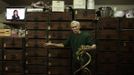 Snake shop owner Mak Tai-kong, 84, holds snakes which were caught in mainland China, in front of wooden cabinets containing snakes, at his snake soup store in Hong Kong January 29, 2013. Mak is one of scores in Hong Kong who have through generations tamed snakes to make soup out of them, a traditional cuisine believed to be good for the health. Yet the people behind providing fresh snakes for the savoury meal thought to speed up the body's blood flow and keep it strong in the cold winter months may be doomed, with young people increasingly reluctant to take on a job they see as hard and dirty. Picture taken January 29, 2013. REUTERS/Bobby Yip (CHINA - Tags: ANIMALS FOOD SOCIETY TPX IMAGES OF THE DAY) Published: Úno. 7, 2013, 2:02 odp.