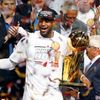 Miami Heat's James holds the Larry O'Brien Trophy and the Bi