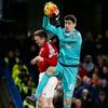 Chelsea's Thibaut Courtois in action with Manchester United's Wayne Rooney