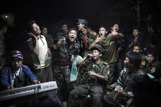 Julius Schrank, a German photographer working for De Volkskrant won 1st Prize Daily Life Single category of the 2014 World Press Photo contest with this picture of Kachin Independence Army fighters drinking and celebrating at a funeral of one of their commanders who died the day before, in Burma, taken March 15, 2013.