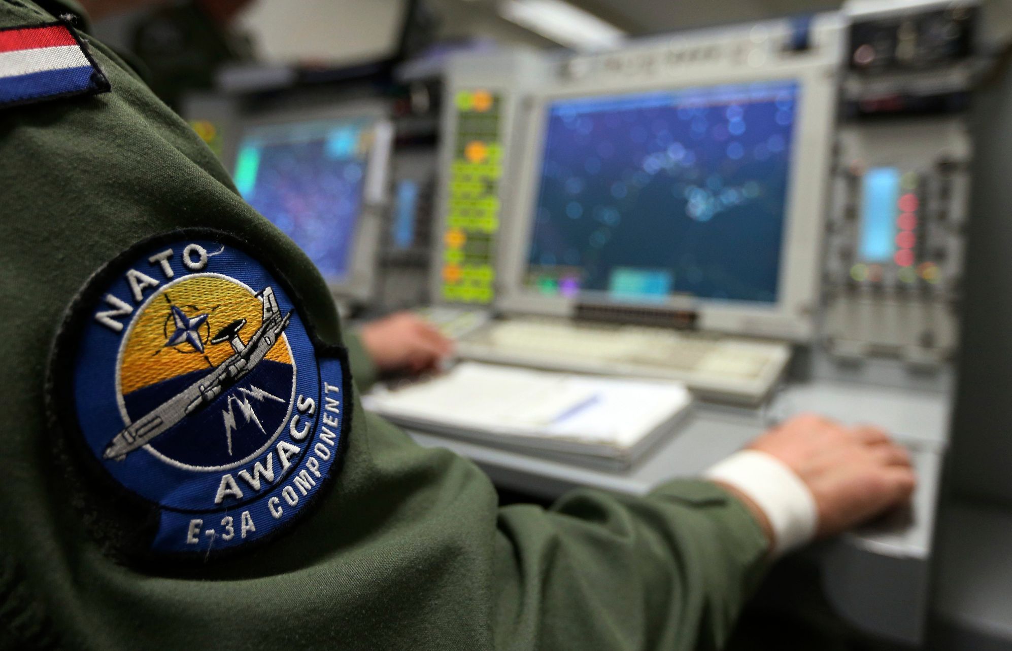 The patch of NATO AWACS (Airborne Warning and Control Systems) aircraft is seen attached to uniform of a controller during surveillance flight over Romania