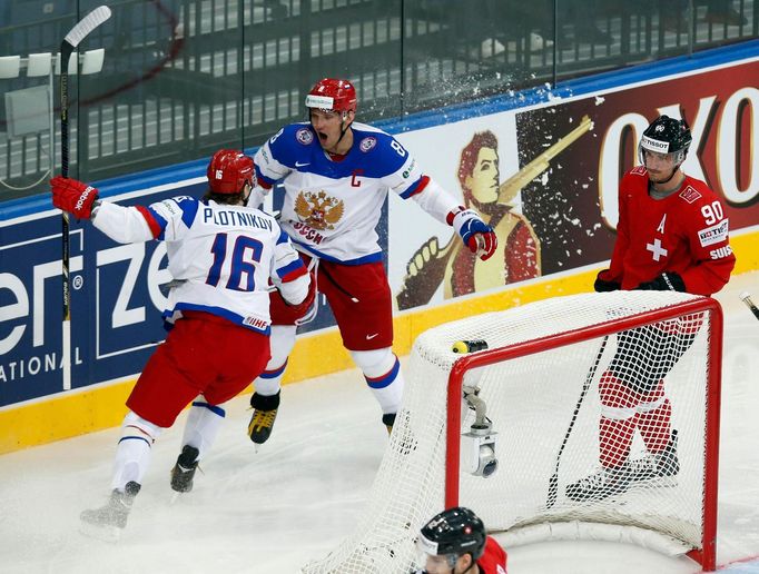 Russia's Sergei Plotnikov (16) celebrates his goal against Switzerland with team mate Alexander Ovechkin (C) as Switzerland's Roman Josi (R) looks on during their men's i