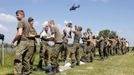 German Bundeswehr armed forces soldiers carry sandbags on a damaged dyke at the river Elbe at the village of Hohengoehren, north of Magdeburg June 10, 2013. Tens of thousands of people have been forced to leave their homes and there have been at least a dozen deaths as a result of floods that have hit Germany, Austria, Slovakia, Poland and the Czech Republic over the past week. REUTERS/Fabrizio Bensch (GERMANY - Tags: DISASTER ENVIRONMENT)