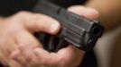 Phil Burns, a firearms instructor, holds a handgun that he carries as part of his survival supplies at his home in American Fork, Utah, December 14, 2012. While most "preppers" discount the Mayan calendar prophecy, many are preparing to be self-sufficient for threats like nuclear war, natural disaster, famine and economic collapse. Picture taken December 14, 2012. REUTERS/Jim Urquhart (UNITED STATES - Tags: SOCIETY) Published: Pro. 18, 2012, 5:23 odp.