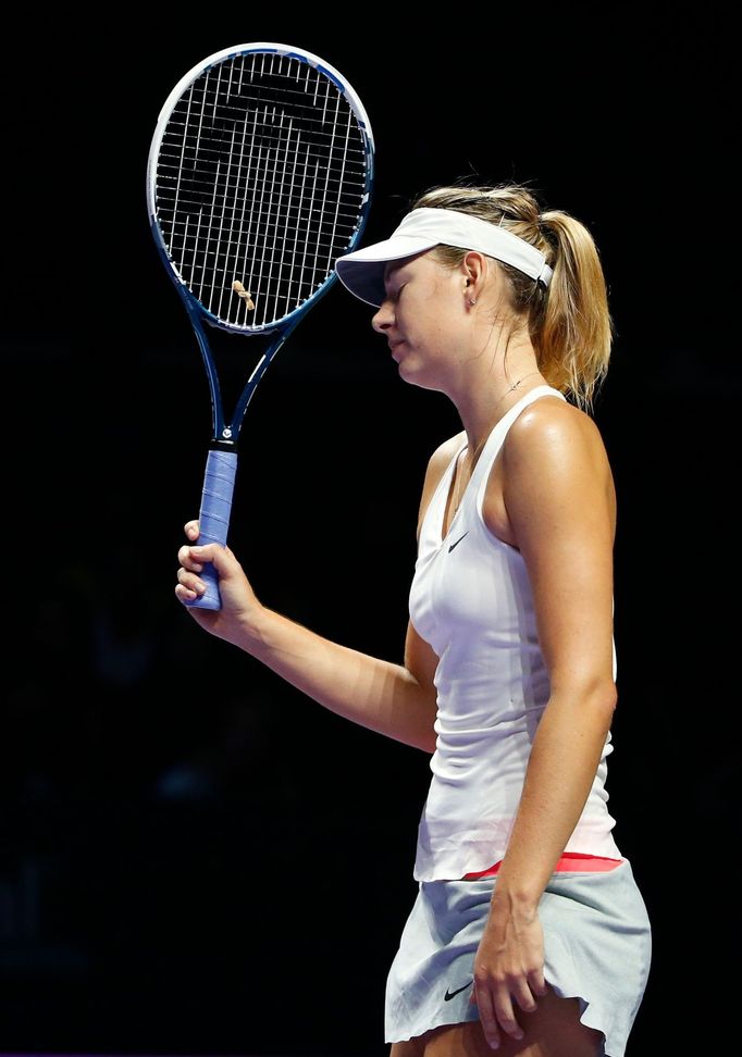 Maria Sharapova of Russia reacts after losing a point to Petra Kvitova of the Czech Republic during their WTA Finals tennis match at the Singapore Indoor Stadium October