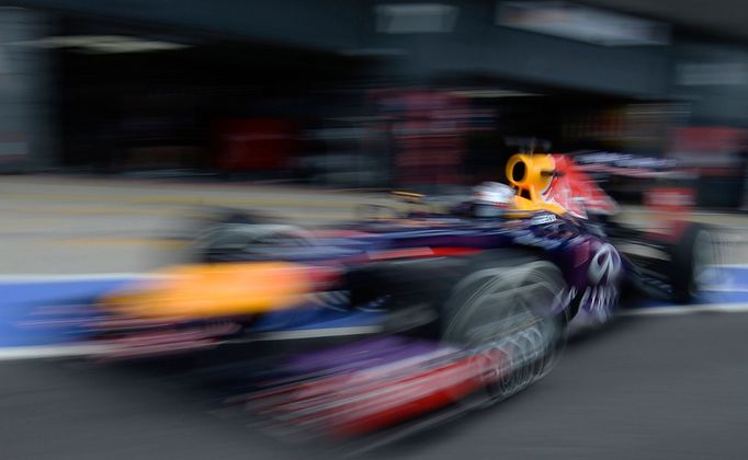 Red Bull Formula One driver Sebastian Vettel of Germany drives out of the pit lane during qualifying for the British Grand Prix at the Silverstone Race circuit, central E