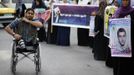 Wheelchair-bound Palestinian freelance photographer Moamen Qreiqea adjusts his camera strap while covering protesters calling for the release of Palestinian prisoners from Israeli jails, in Gaza City October 1, 2012. Qreiqea, 25, lost both his legs in an Israeli air strike in 2008 while taking pictures east of Gaza. The father of two is determined to continue his career despite his disability. REUTERS/Suhaib Salem (GAZA - Tags: MEDIA SOCIETY) Published: Říj. 1, 2012, 3:39 odp.