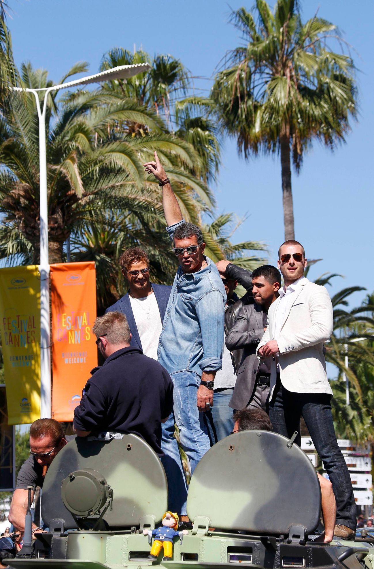 Cast members  Kellan Lutz, Antonio Banderas, Victor Ortiz and Glen Powell pose on a tank on the Croisette to promote the film &quot;The Expendables 3&quot; during the 67th Cannes Film Festival in Cann