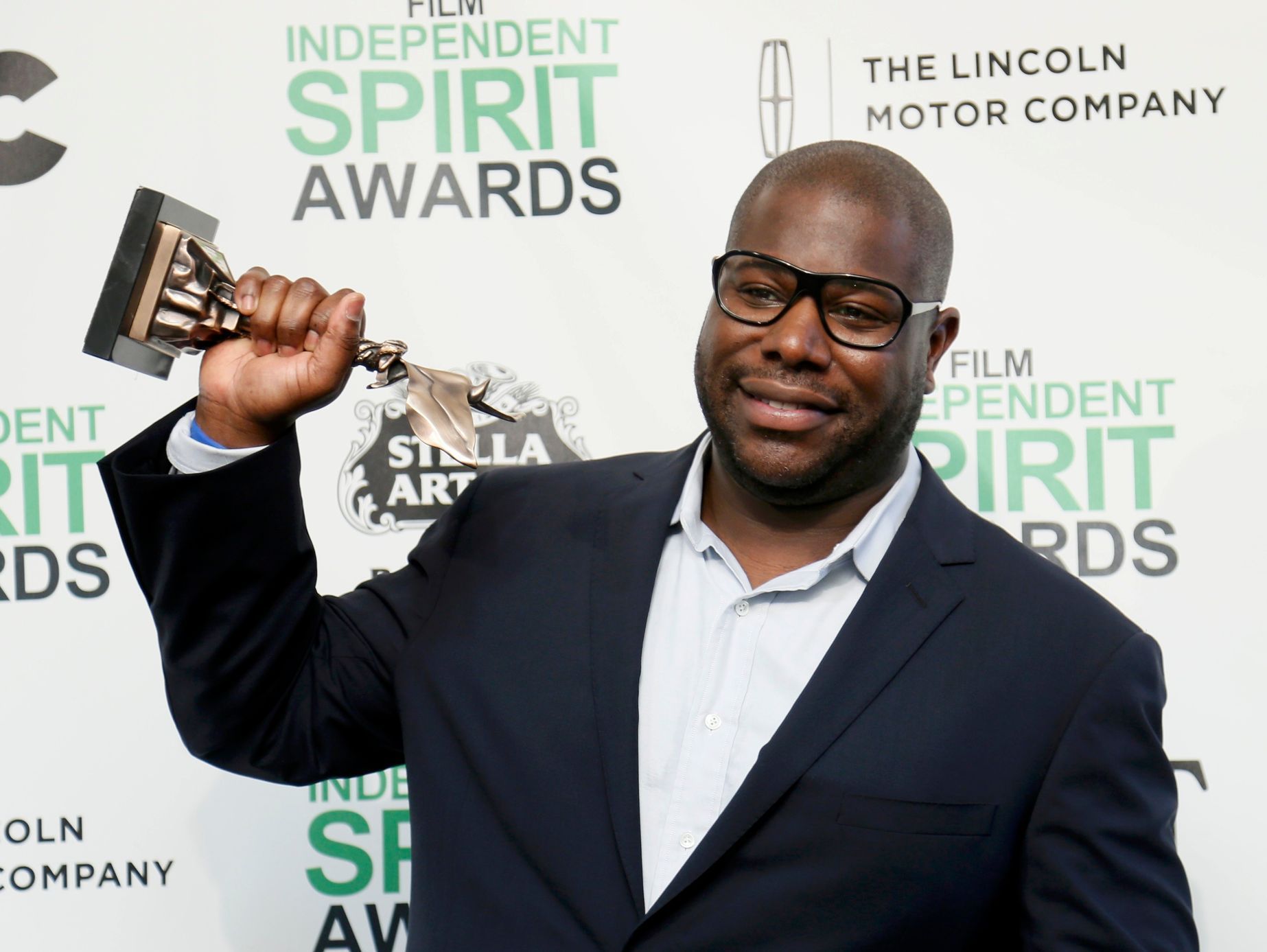 Director Steve McQueen poses backstage with his Best Feature award for the film &quot;12 Years a Slave&quot; at the 2014 Film Independent Spirit Awards in Santa Monica