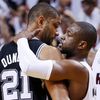 Heat's Wade hugs Spurs' Duncan as the Heat's James approache