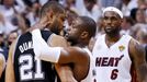 Miami Heat's Dwyane Wade hugs San Antonio Spurs' Tim Duncan (L) as the Heat's LeBron James (R) approaches after the Heat defeated the Spurs to win Game 7 of their NBA Fin