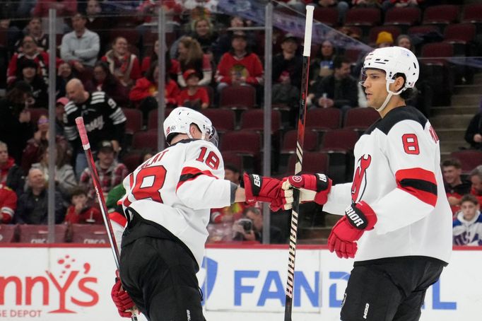 Mar 26, 2025; Chicago, Illinois, USA; New Jersey Devils left wing Ondrej Palat (18) celebrates his goal against the Chicago Blackhawks with defenseman Johnathan Kovacevic