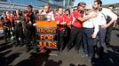 Marussia Formula One driver Max Chilton of Britain (C) and his team members pray for Marussia Formula One driver Jules Bianchi of France who had an accident in the previo