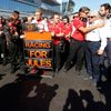 Marussia Formula One driver Chilton of Britain and his team members pray for Marussia Formula One driver Bianchi of France who had accident in previous race, before the first Russian Grand Prix in Soc