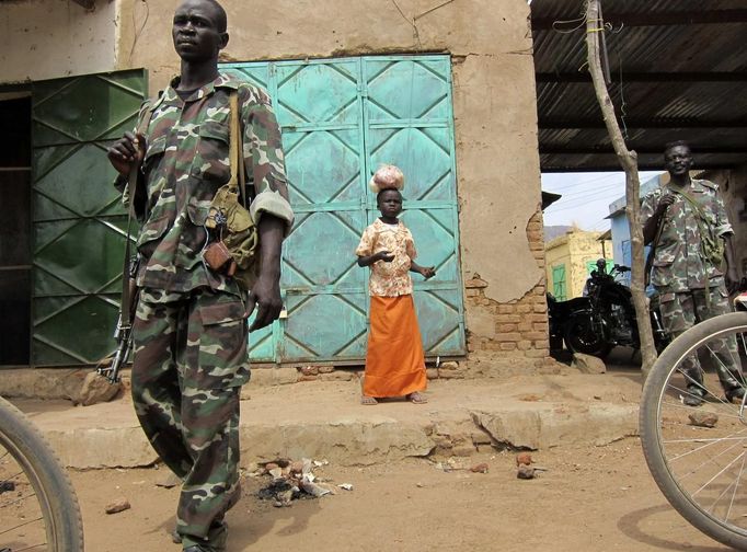 Armed soldiers stand guard at the Talodi market in South Kordofan