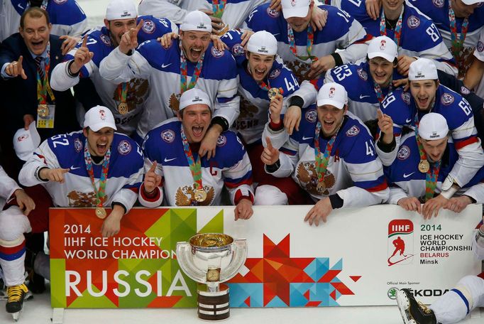 Russia's players celebrate with the trophy after winning their men's ice hockey World Championship final game against Finland at Minsk Arena in Minsk May 25, 2014. REUTER