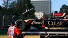 Workers load the car of Lotus Formula One driver Romain Grosjean of France onto a truck during the second practice session of the Australian F1 Grand Prix at the Albert P