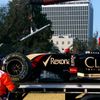 Workers load the car of Lotus Formula One driver Grosjean of France onto a truck during the second practice session of the Australian F1 Grand Prix in Melbourne