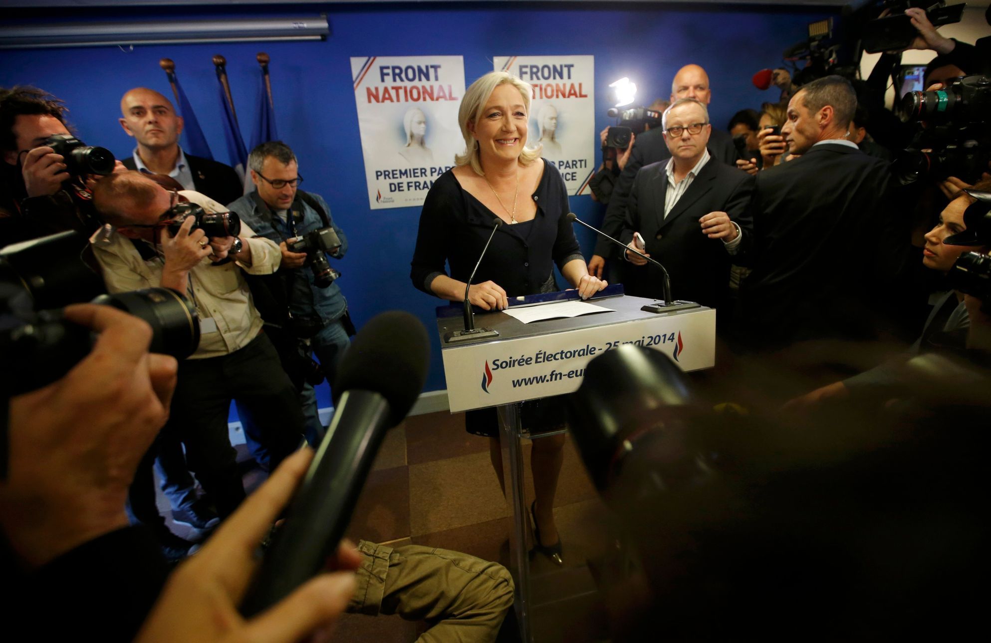 Journalists surround Marine Le Pen, France's National Front political party head, who reacts to results after the polls closed in the European Parliament elections at the party's headquarters in Nante