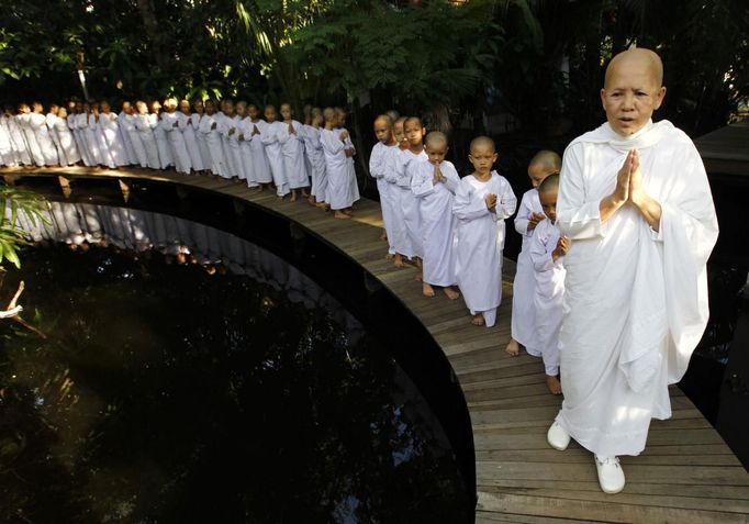 A Buddhist nun walks in line with novice Thai nuns at the Sathira Dammasathan Buddhist meditation centre in Bangkok