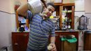 Sofiane Moussaoui, a 26 year-old waiter, poses for a picture as he serves tea for customers in a cafe in Algiers, April 22, 2012. Moussaoui studied for five years at the University 08 May 1945 Guelma where he received a masters degree in corporate finance. He hoped to find a job as an auditor but has been working as a waiter for over a year.