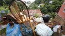 Furniture and other belongings are stacked outside as a resident prepares to move out of a house damaged by a mudslide caused by the passing of Tropical Storm Isaac at Upper Neckles Drive, Carenage August 23, 2012. Tropical Storm Isaac unleashed heavy rain and winds off Puerto Rico and the Virgin Islands as it moved across the Caribbean on Thursday and could strengthen into a hurricane before tearing across the Dominican Republic and Haiti. REUTERS/Andrea De Silva (TRINIDAD AND TOBAGO - Tags: DISASTER ENVIRONMENT) Published: Srp. 24, 2012, 2:12 dop.