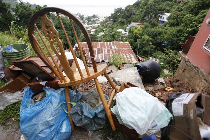 Furniture and other belongings are stacked outside as a resident prepares to move out of a house damaged by a mudslide caused by the passing of Tropical Storm Isaac at Upper Neckles Drive, Carenage August 23, 2012. Tropical Storm Isaac unleashed heavy rain and winds off Puerto Rico and the Virgin Islands as it moved across the Caribbean on Thursday and could strengthen into a hurricane before tearing across the Dominican Republic and Haiti. REUTERS/Andrea De Silva (TRINIDAD AND TOBAGO - Tags: DISASTER ENVIRONMENT) Published: Srp. 24, 2012, 2:12 dop.