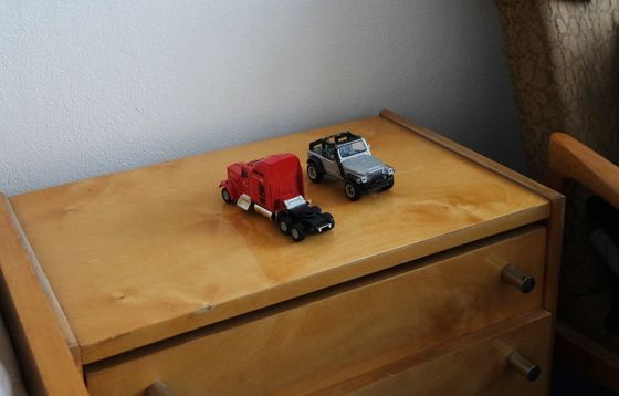 Two children, two toy cars on the bedside table.  Ukrainian boys were shocked by the war, now they sleep more peacefully.