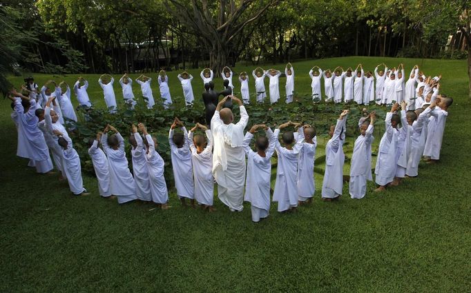 Buddhist nun prays with novice Thai nuns at the Sathira Dammasathan Buddhist meditation centre in Bangkok