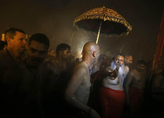 REFILE - CORRECTING BYLINE Hindu devotees arrive to attend the first "Shahi Snan" (grand bath) at the ongoing "Kumbh Mela", or Pitcher Festival, in the northern Indian city of Allahabad January 14, 2013. Upwards of a million elated Hindu holy men and pilgrims took a bracing plunge in India's sacred Ganges river to wash away lifetimes of sins on Monday, in a raucous start to an ever-growing religious gathering that is already the world's largest. REUTERS/Ahmad Masood (INDIA - Tags: RELIGION SOCIETY) Published: Led. 14, 2013, 8:34 dop.