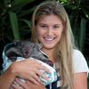Eugenie Bouchard of Canada poses with a baby wombat from Melbourne Zoo in the Player Cafe at the Australian Open 2014 tennis tournament in Melbourne