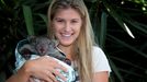 Eugenie Bouchard of Canada poses with a baby wombat from Melbourne Zoo in the Pl