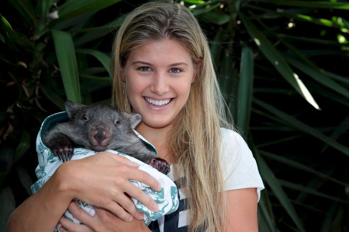 Eugenie Bouchard of Canada poses with a baby wombat from Melbourne Zoo in the Pl