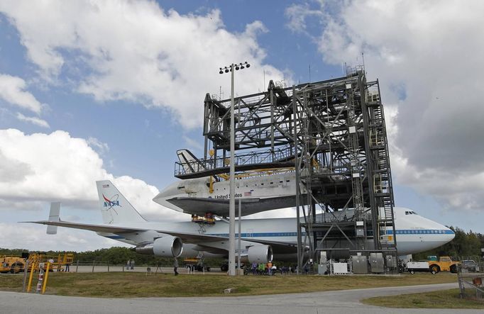 The space shuttle Discovery is attached to a NASA 747 aircraft which was towed into the Mate Demate facility, at Kennedy Space Center in Cape Canaveral