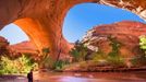 A hiker at Jacob Hamblin Arch in Coyote Gulch, Grand Staircase-Escalante National Monument, Utah, United States