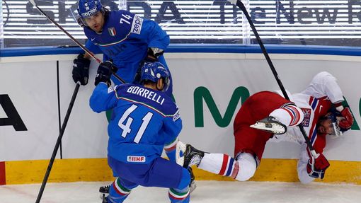 Jakub Klepis of the Czech Republic (R) crashes into the boards next to Davide Nicoletti (top) and David Borelli (L) during the first period of their men's ice hockey Worl