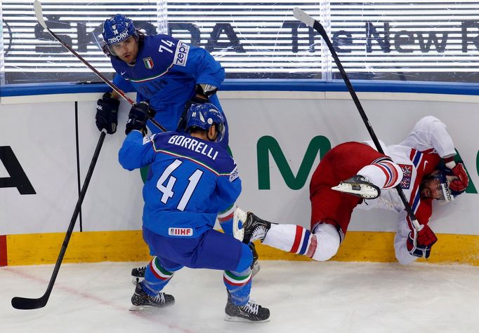 Jakub Klepis of the Czech Republic (R) crashes into the boards next to Davide Nicoletti (top) and David Borelli (L) during the first period of their men's ice hockey Worl