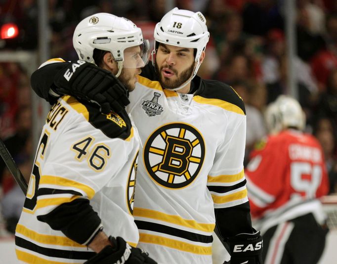 Boston Bruins center David Krejci (46) and Nathan Horton (18) celebrate assisting on Milan Lucic's first period goal against the Chicago Blackhawks during Game 1 of their