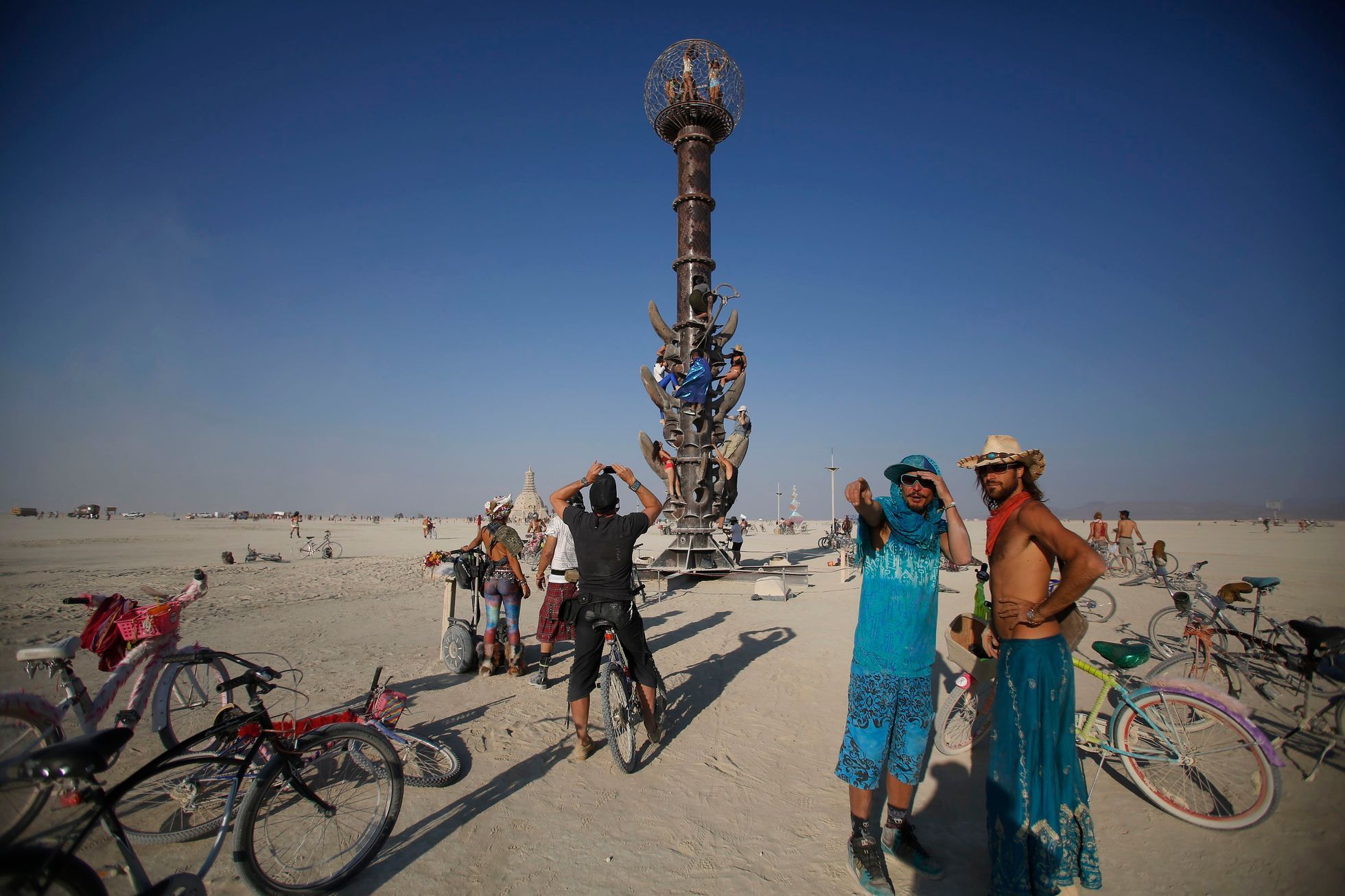 Participants climb the Minaret art installation on the last day of the Burning Man 2014 &quot;Caravansary&quot; arts and music festival in the Black Rock Desert of Nevada