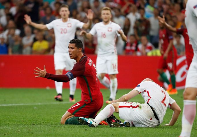 Portugal's Cristiano Ronaldo reacts after a challenge from Poland's Michal Pazdan