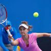 Lauren Davis of the United States hits a return to Julia Goerges of Germany during their women's singles match at the Australian Open 2014 tennis tournament in Melbourne