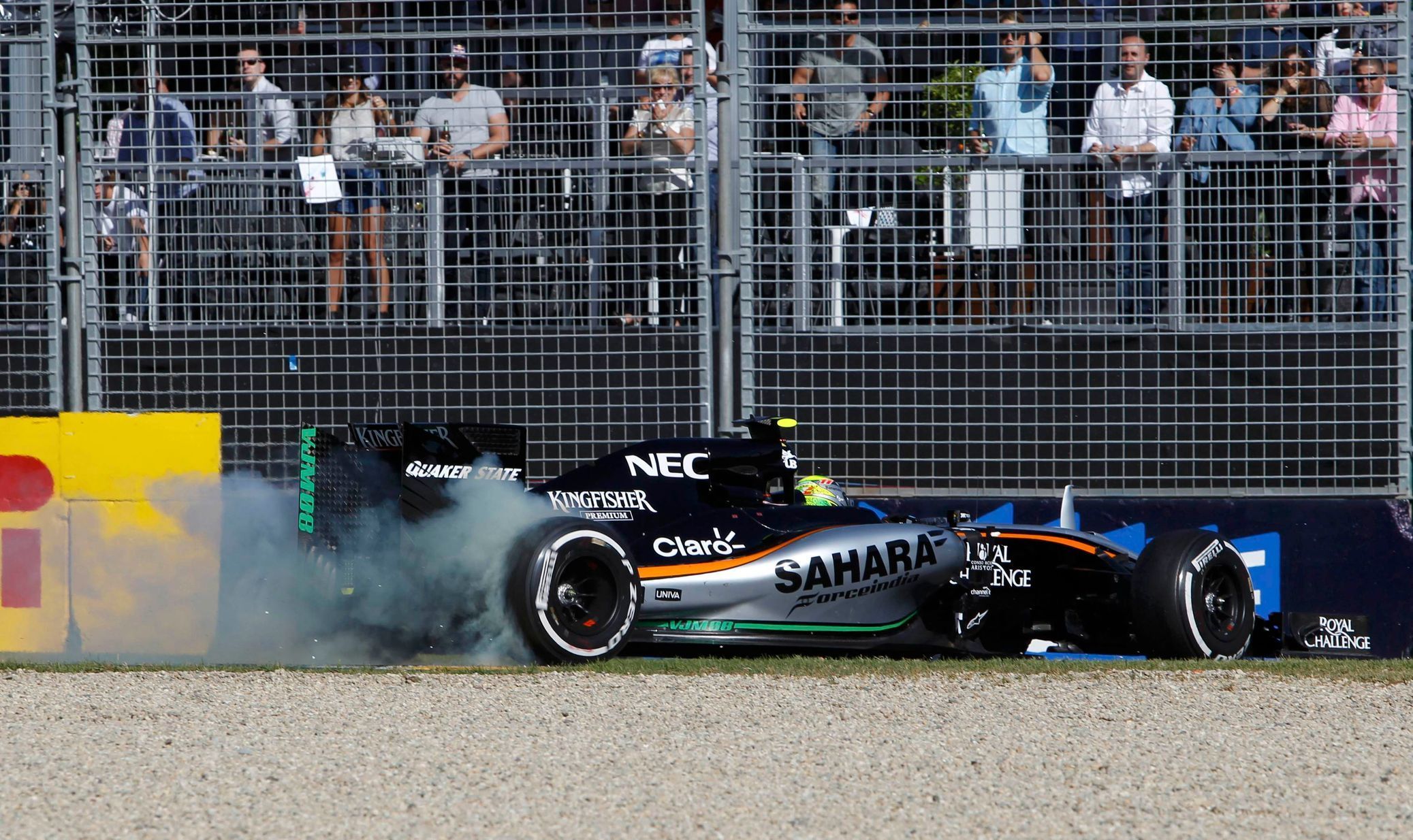 Force India Formula One driver Sergio Perez of Mexico drives into the gravel after being clipped by McLaren Formula One driver Jenson Button of Britain during the Australian F1 Grand Prix at the Alber