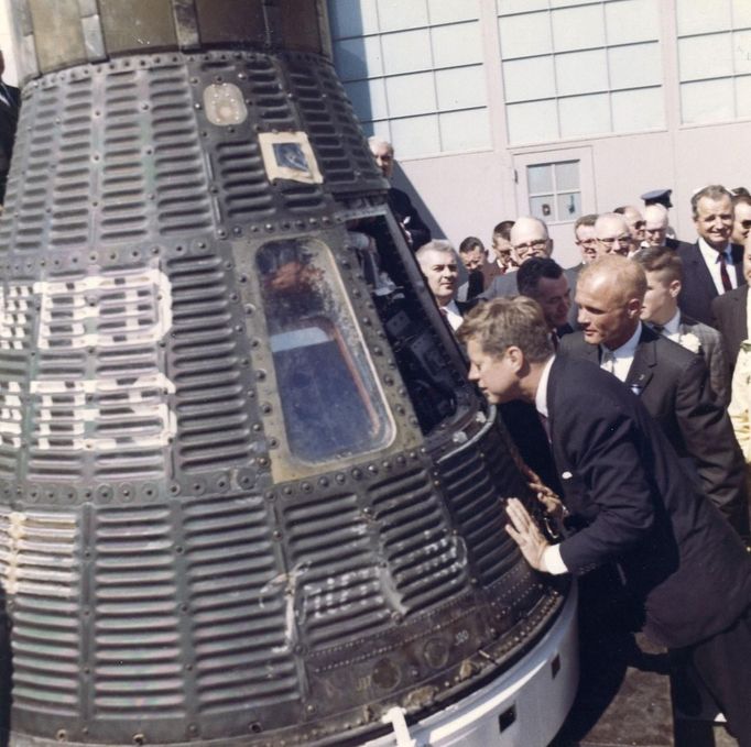 Former United States President John F. Kennedy and astronaut Lieutenant Colonel John Glenn, Jr. (2NDL) look inside the space capsule Friendship 7 following the presentation ceremony of the National Aeronautics and Space Administration (NASA) Distinguished Service Medal to Glenn in Cape Canaveral, Florida, in this handout image taken on February 23, 1962. The Friendship 7 carried Glenn in orbit around the earth three times