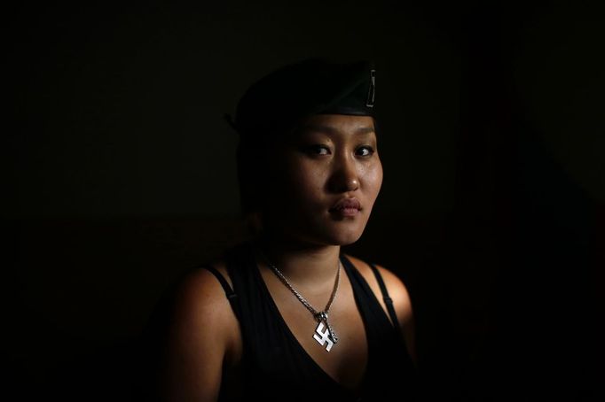 Uranjargal, a leader of the Mongolian neo-Nazi group Tsagaan Khass, poses for a portrait at the group's headquarters in Ulan Bator June 23, 2013. The group has rebranded itself as an environmentalist organisation fighting pollution by foreign-owned mines, seeking legitimacy as it sends Swastika-wearing members to check mining permits. Over the past years, ultra-nationalist groups have expanded in the country and among those garnering attention is Tsagaan Khass, which has recently shifted its focus from activities such as attacks on women it accuses of consorting with foreign men to environmental issues, with the stated goal of protecting Mongolia from foreign mining interests. This ultra-nationalist group was founded in the 1990s and currently has 100-plus members. Picture taken June 23, 2013. REUTERS/Carlos Barria (MONGOLIA - Tags: SOCIETY POLITICS BUSINESS EMPLOYMENT ENVIRONMENT TPX IMAGES OF THE DAY) ATTENTION EDITORS: PICTURE 03 OF 25 FOR PACKAGE 'MONGOLIA'S ENVIRONMENTAL NEO-NAZIS'. TO FIND ALL IMAGES SEARCH 'TSAGAAN KHASS' Published: Čec. 2, 2013, 9:57 dop.