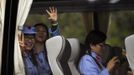 Mid-level government officials dressed in red army uniforms wave as they leave on a bus during their 5-day training course at the communist party school called China Executive Leadership Academy of Jinggangshan, in Jiangxi province September 21, 2012. China Executive Leadership Academy was established in 2005 by the Central Committee of the Communist Party of China, after the 16th Communist Party Congress in 2002. By the end of August 2012, the academy has held 789 training classes for almost 40,000 people. During the course, trainees listen and sing revolutionary songs, visit old revolutionary sites and review historical communist materials. China has yet to announce the starting date for the 18th Communist Party Congress, China's biggest political meeting in a decade, which will see the transfer of power from President Hu Jintao and Premier Wen Jiabao to a new generation. REUTERS/Carlos Barria (CHINA - Tags: POLITICS SOCIETY TRANSPORT) Published: Zář. 21, 2012, 2:23 odp.