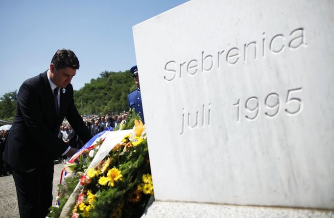 Croatian Prime Minister Zoran Milanovic lays flowers near a memorial plaque at Memorial Center in Potocari during a mass burial, near Srebrenica July 11, 2012. The bodies of 520 recently identified victims of the Srebrenica massacr is buried on July 11, the anniversary of the massacre when Bosnian Serb forces commanded by Ratko Mladic slaughtered 8,000 Muslim men and boys and buried them in mass graves, in Europe's worst massacre since World War Two. REUTERS/Dado Ruvic (BOSNIA - Tags: CONFLICT OBITUARY ANNIVERSARY POLITICS)