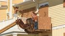 Crew work to board up homes in Oak Island, N.C., Tuesday Sept. 11, 2018, in preparation for Hurricane Florence.