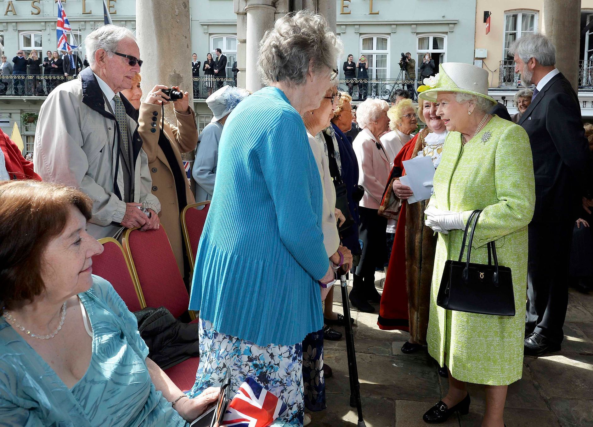 Britain's Queen Elizabeth greets women in their nineties as she walks through Windsor on her 90th Birthday, in Windsor