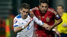 Alba of Spain is challenged by Pekarik of Slovakia during their Euro 2016 qualification soccer match at the MSK stadium in Zilina